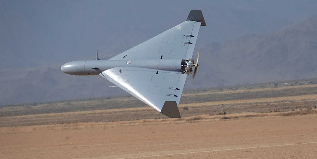 Shahed-class one-way attack drone in flight over desert terrain